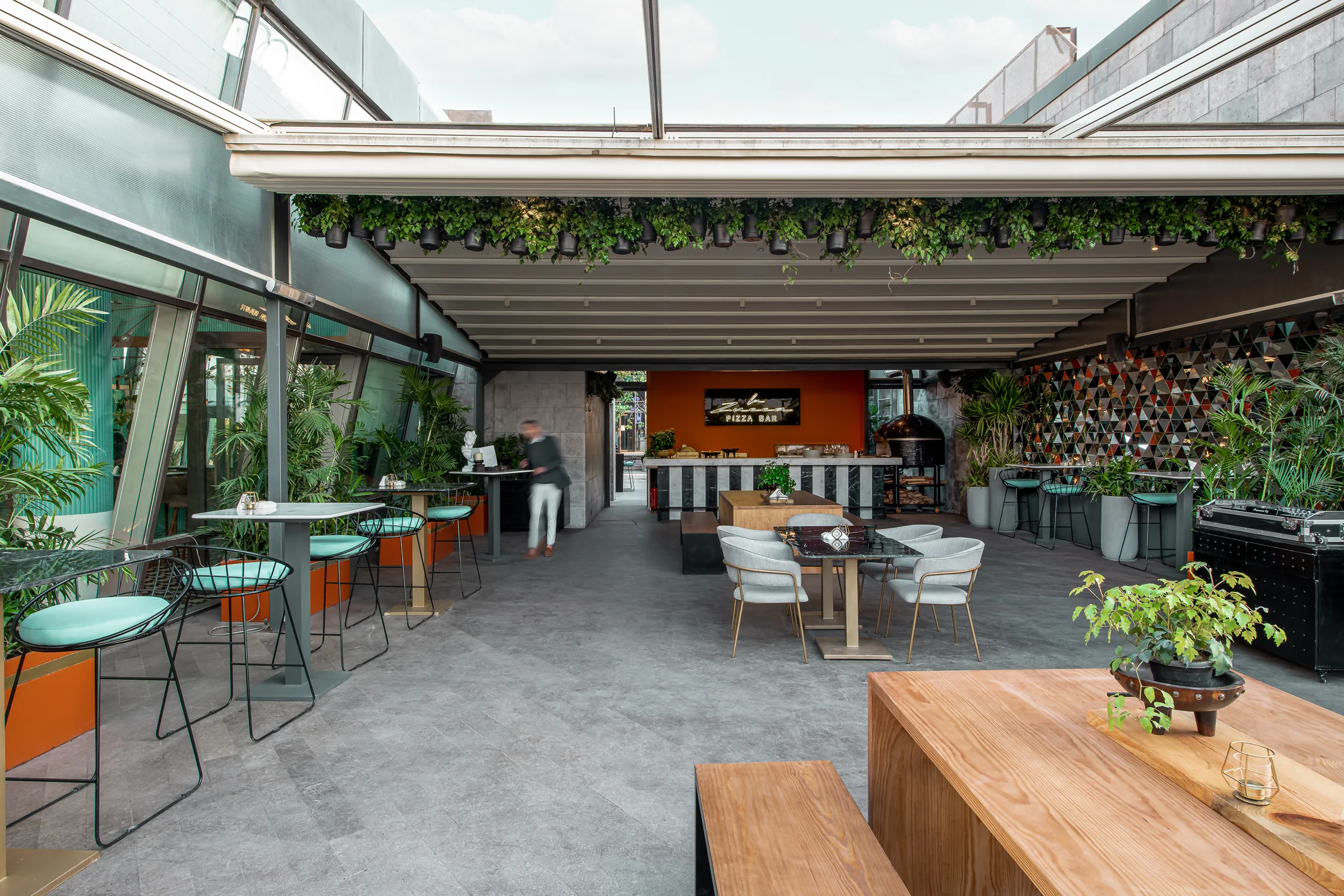 Terrace bar and high stools in daylight.